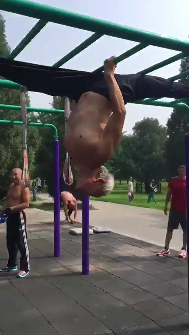 Senior calisthenics master performing advanced moves with effortless precision