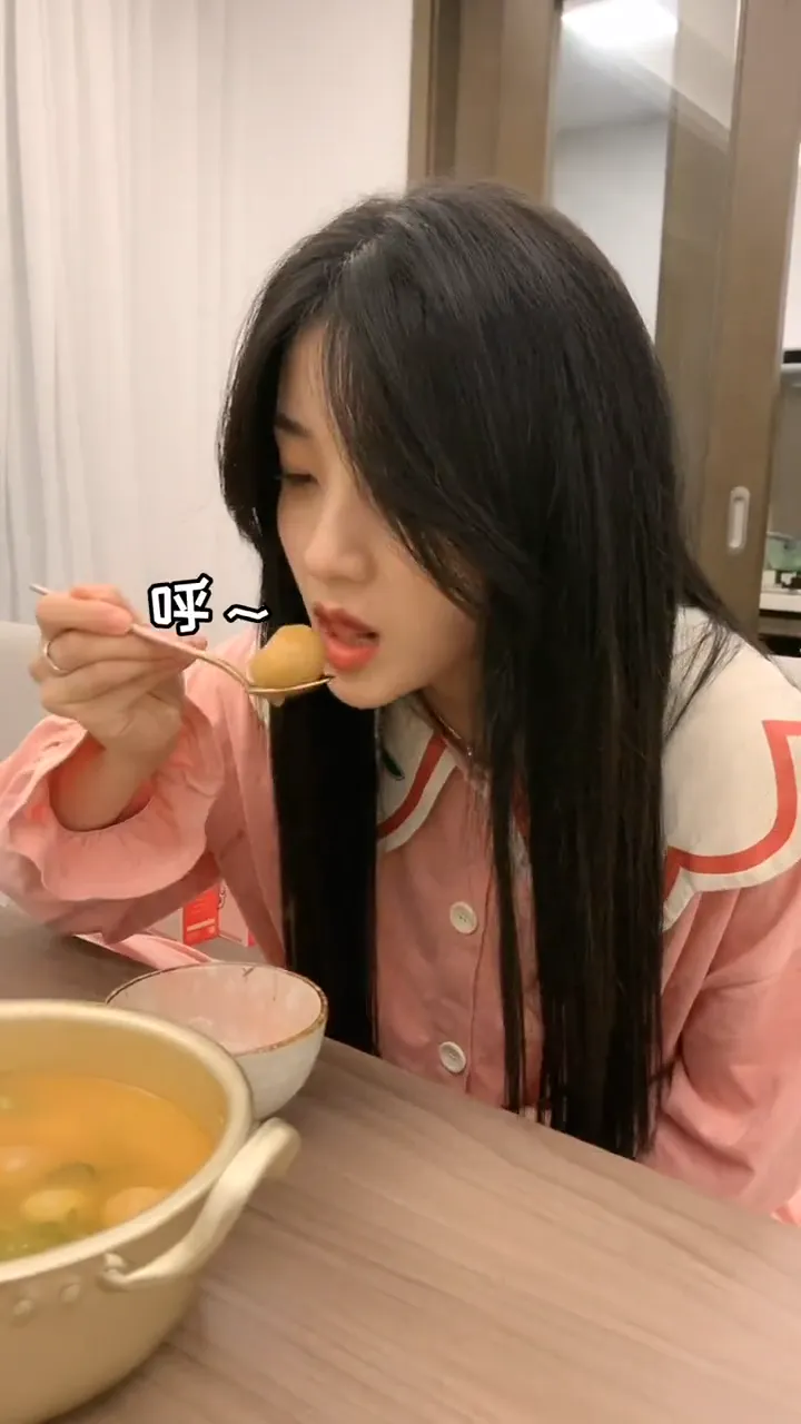 Girlfriend repeatedly trying to eat a scorching hot meatball and failing each time