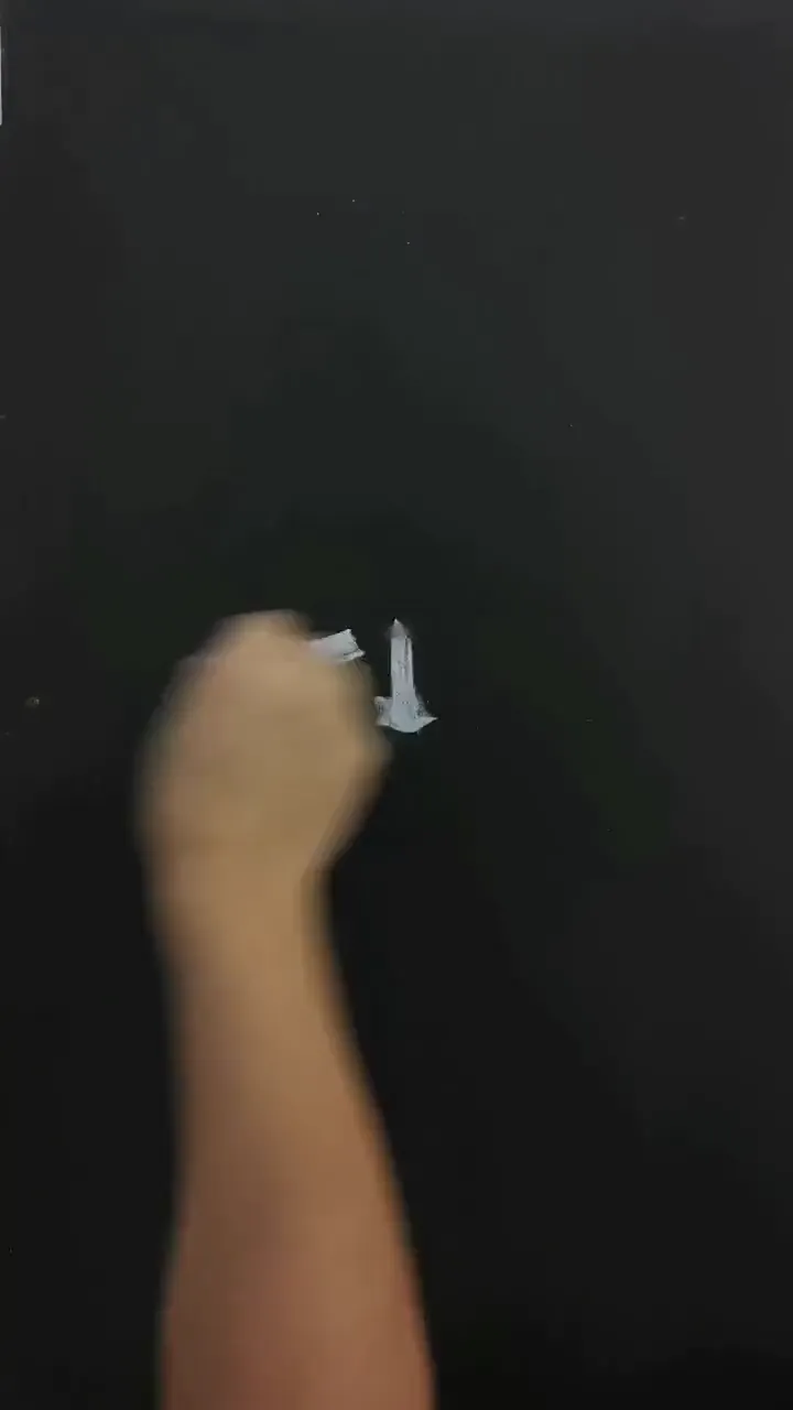 Precise brushwork creating delicate details on a tiny surface